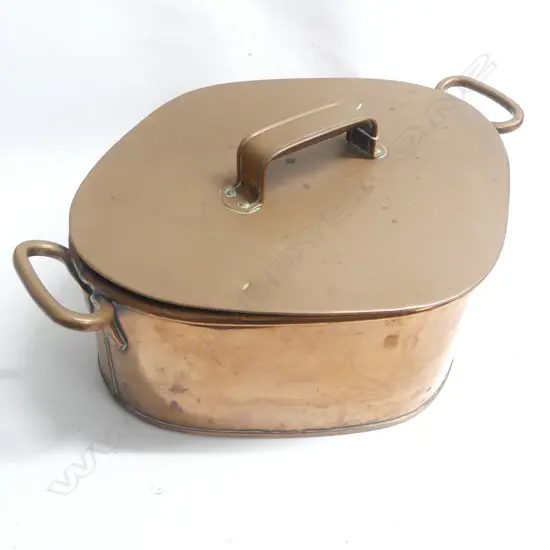 A Victorian copper Turbot pan of rhombus shape to accept the fish with two loop handles to the rim and lid with riveted handle. W.550mm across handles.