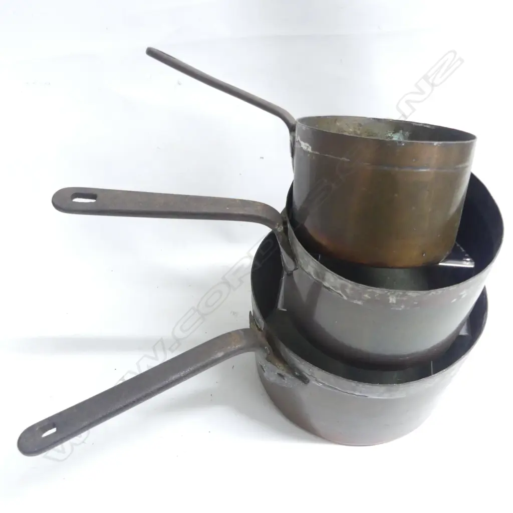 A graduated set of three antique copper saucepans the long iron handles with copper rivets. Dia.140. 175 and 230mm. Image 1++