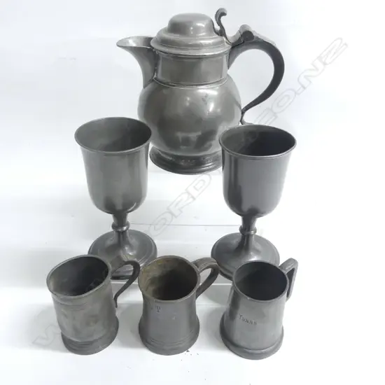An English pewter bulbous bodied lidded ale measure with volute thumb piece to the domed cover H.200mm;  a pair of James Dixon & Sons pewter goblets with bell form bowls H.185mm and three pewter tankards