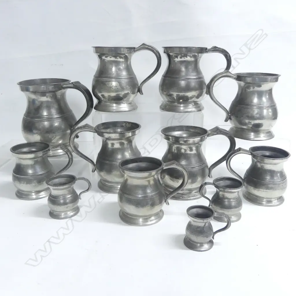 Twelve pewter baluster mugs, one of quart size, five of pint size, three of half pint and three smaller. Image 1++