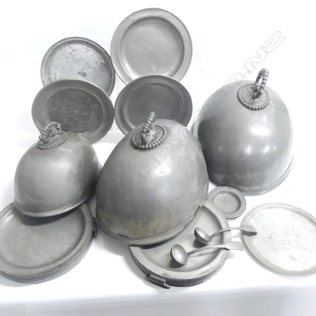A collection of 19thC pewter tablewares comprising: graduated set of three pewter food covers AF; a pair of Georgian period pewter plates Dia.200mm; three Georgian plates, Dia.245mm; a pair of two-handled warming dishes, Dia.230mm; two small plates, Dia.100mm, and two sauce ladles. Image 1++