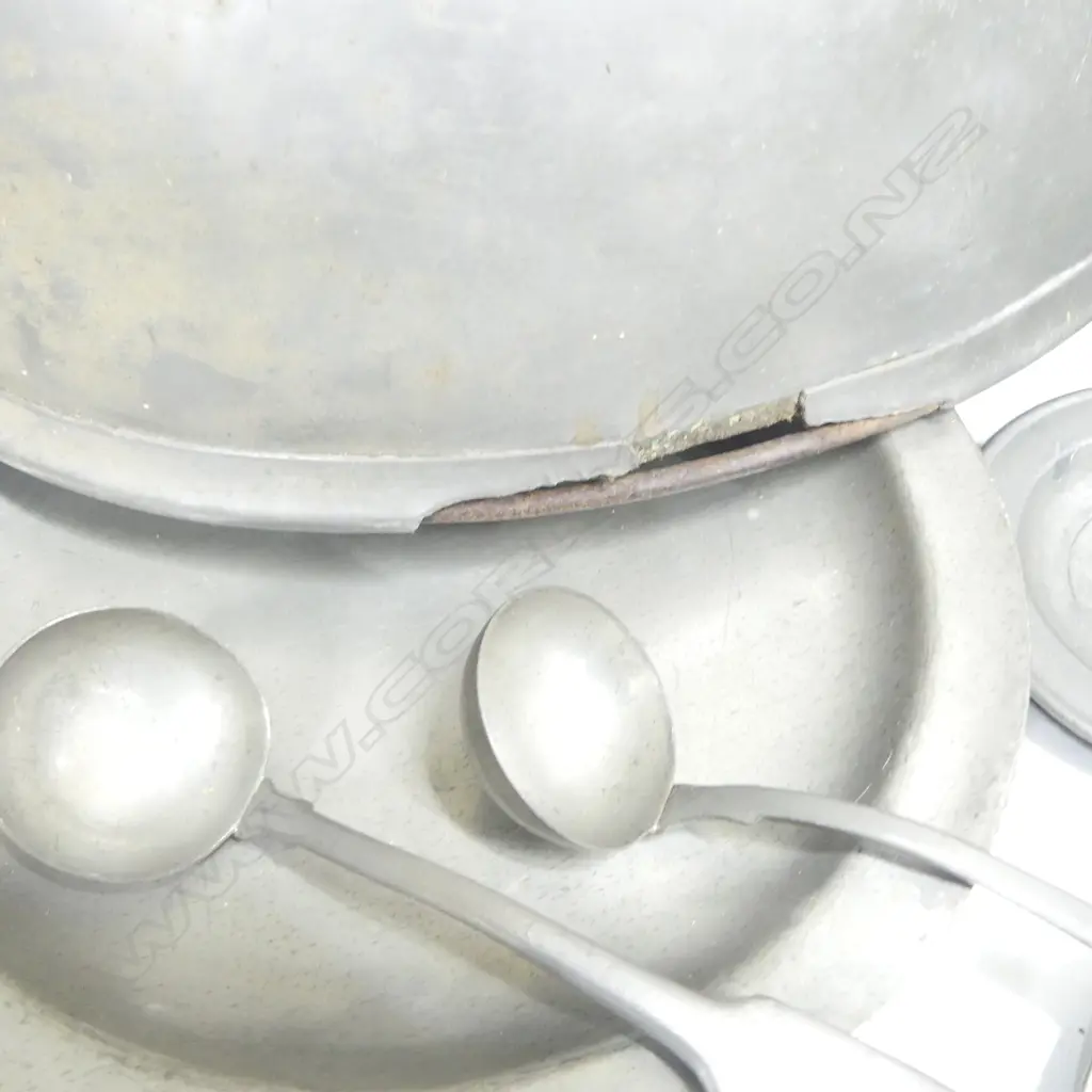 A collection of 19thC pewter tablewares comprising: graduated set of three pewter food covers AF; a pair of Georgian period pewter plates Dia.200mm; three Georgian plates, Dia.245mm; a pair of two-handled warming dishes, Dia.230mm; two small plates, Dia.100mm, and two sauce ladles. Image 1++