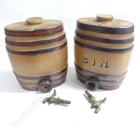 Two Victorian period stoneware spirit barrels: one marked ‘Gin’ in gilt lettering- brown glazed with darker bands, both with brass taps and original stoneware tops. H.270mm