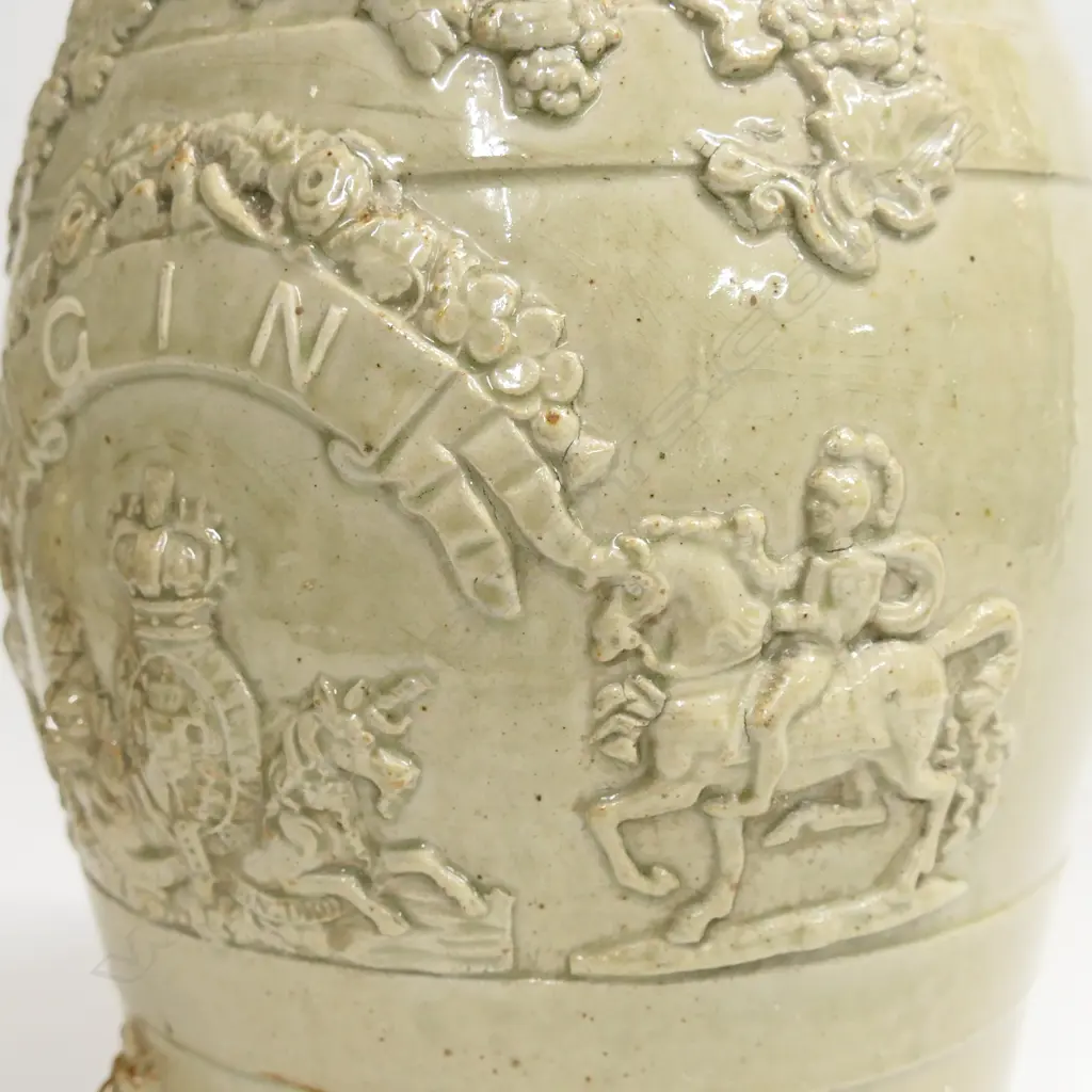 A Victorian salt glazed 'Gin' barrel with British coat of arms and 'GIN' to a ribbon framed by armoured knights on horseback, other relief grape leaf and lions head design. H.355mm Image 1++