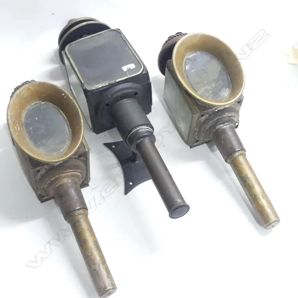 A pair of vintage gig lamps, steel with copper framed oval lenses; along with another black painted gig lamp. AF Image 1++