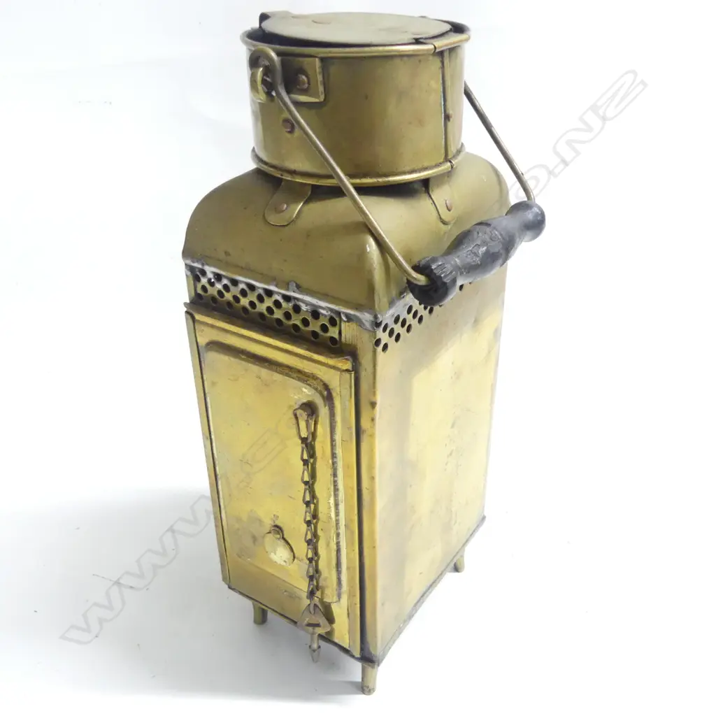 A brass ships' companionway or watch lantern by Eli Griffiths & Sons. 1915 (Birmingham) housing the original oil burner and reflector to the interior. H.335mm. Image 1++