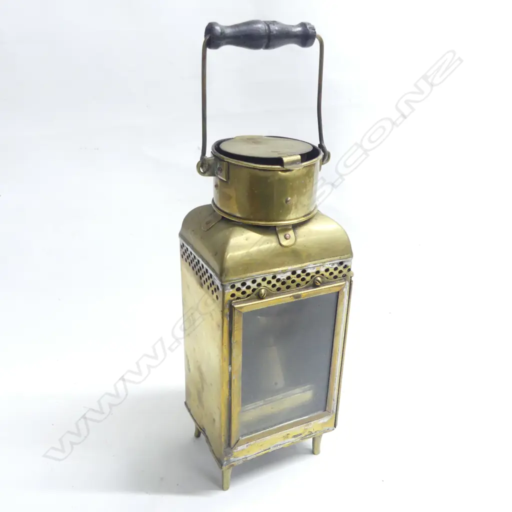 A brass ships' companionway or watch lantern by Eli Griffiths & Sons. 1915 (Birmingham) housing the original oil burner and reflector to the interior. H.335mm. Image 1++