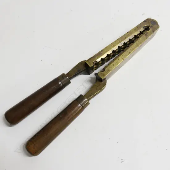 A large brass gang mould for casting 20 round ball bullets.