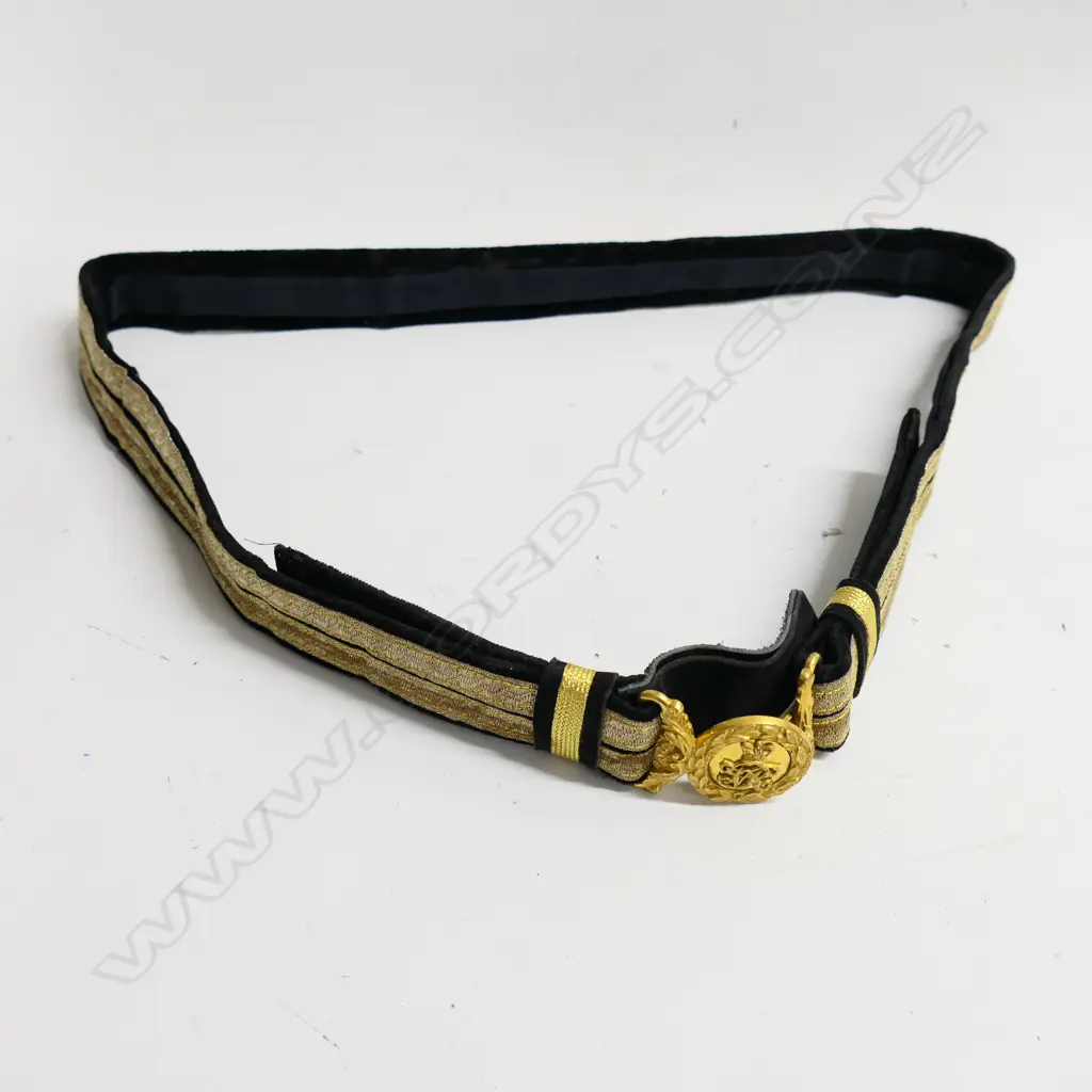 A Victorian officer's black cloth 1¾" wide dress belt with bullion braid and an ornate gilt belt buckle with ‘Crown’ and ‘VR’ surrounded by leaves Image 1++