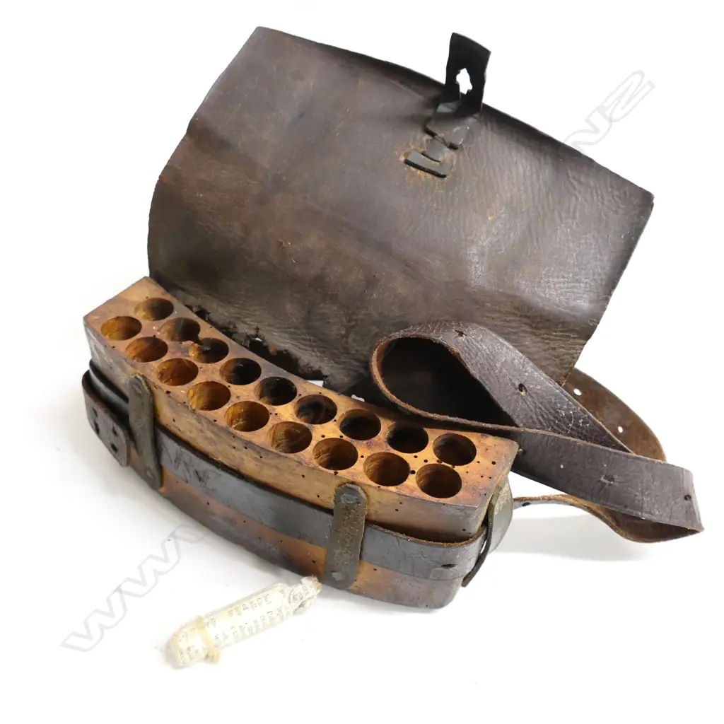 A leather bound ammunition pouch. Possibly used in the New Zealand Wars,  'Henare' etched into belt. Image 1++