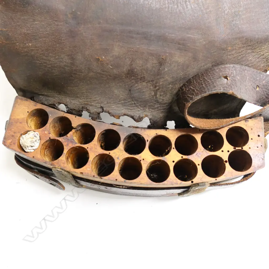 A leather bound ammunition pouch. Possibly used in the New Zealand Wars,  'Henare' etched into belt. Image 1++