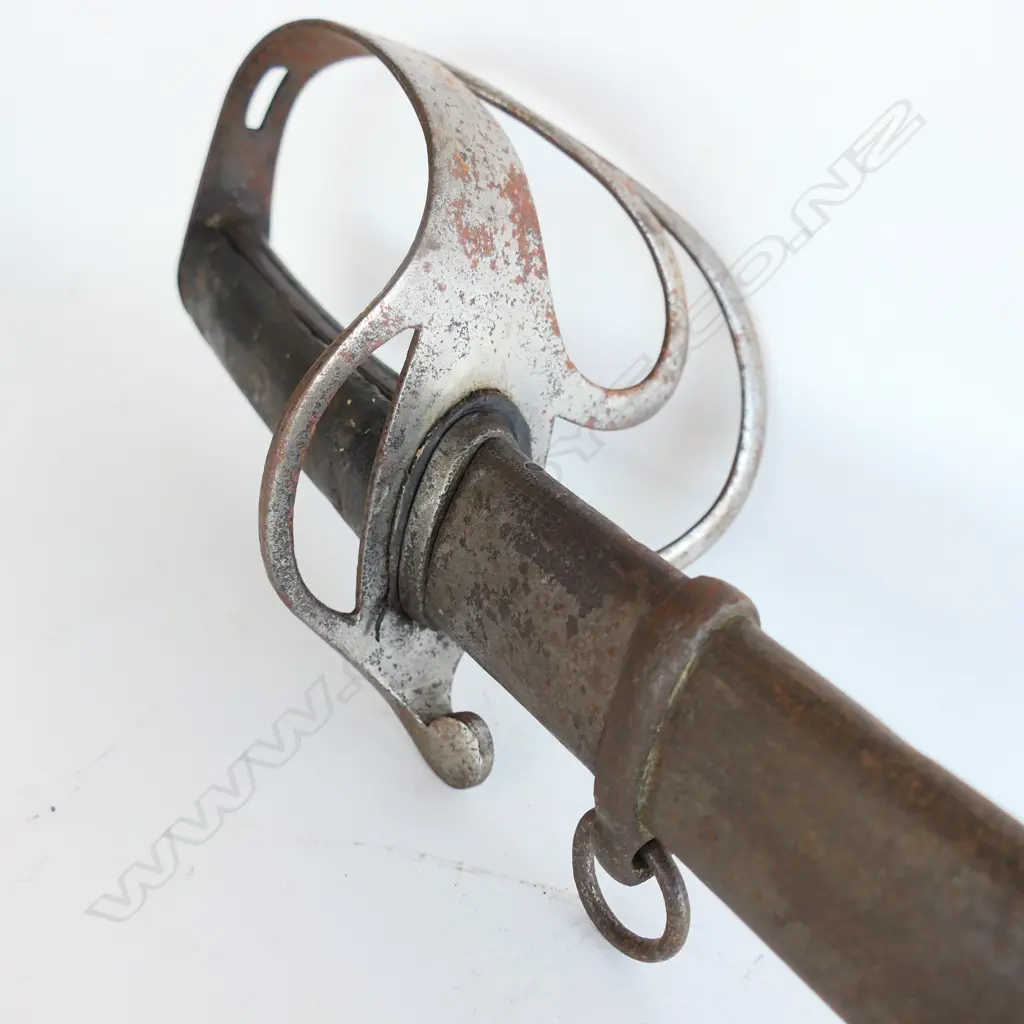 An 1853 Pattern Cavalry Trooper's sword and scabbard, the 895mm single edge fullered steel blade stamped to back edge ‘Mole’ for Robert Mole, Birmingham, Image 1++