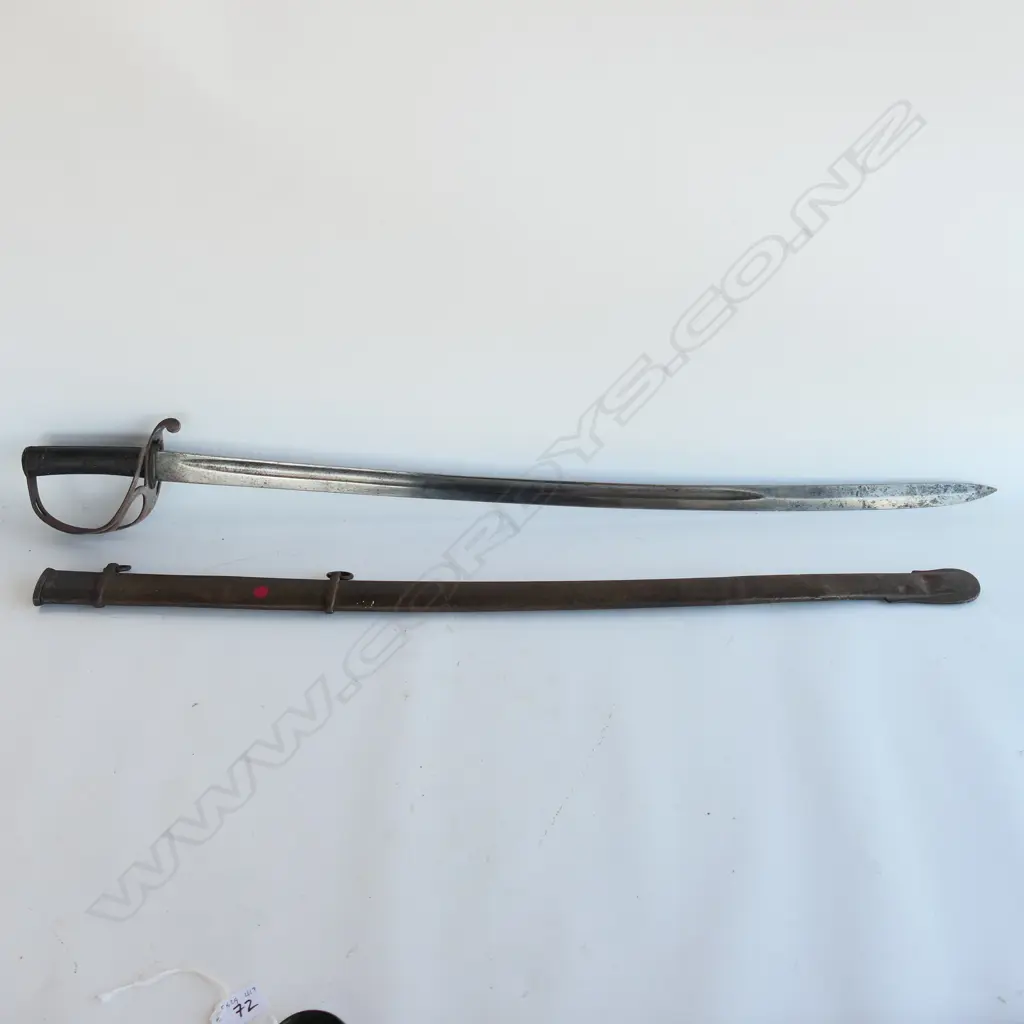 An 1853 Pattern Cavalry Trooper's sword and scabbard, the 895mm single edge fullered steel blade stamped to back edge ‘Mole’ for Robert Mole, Birmingham, Image 1++