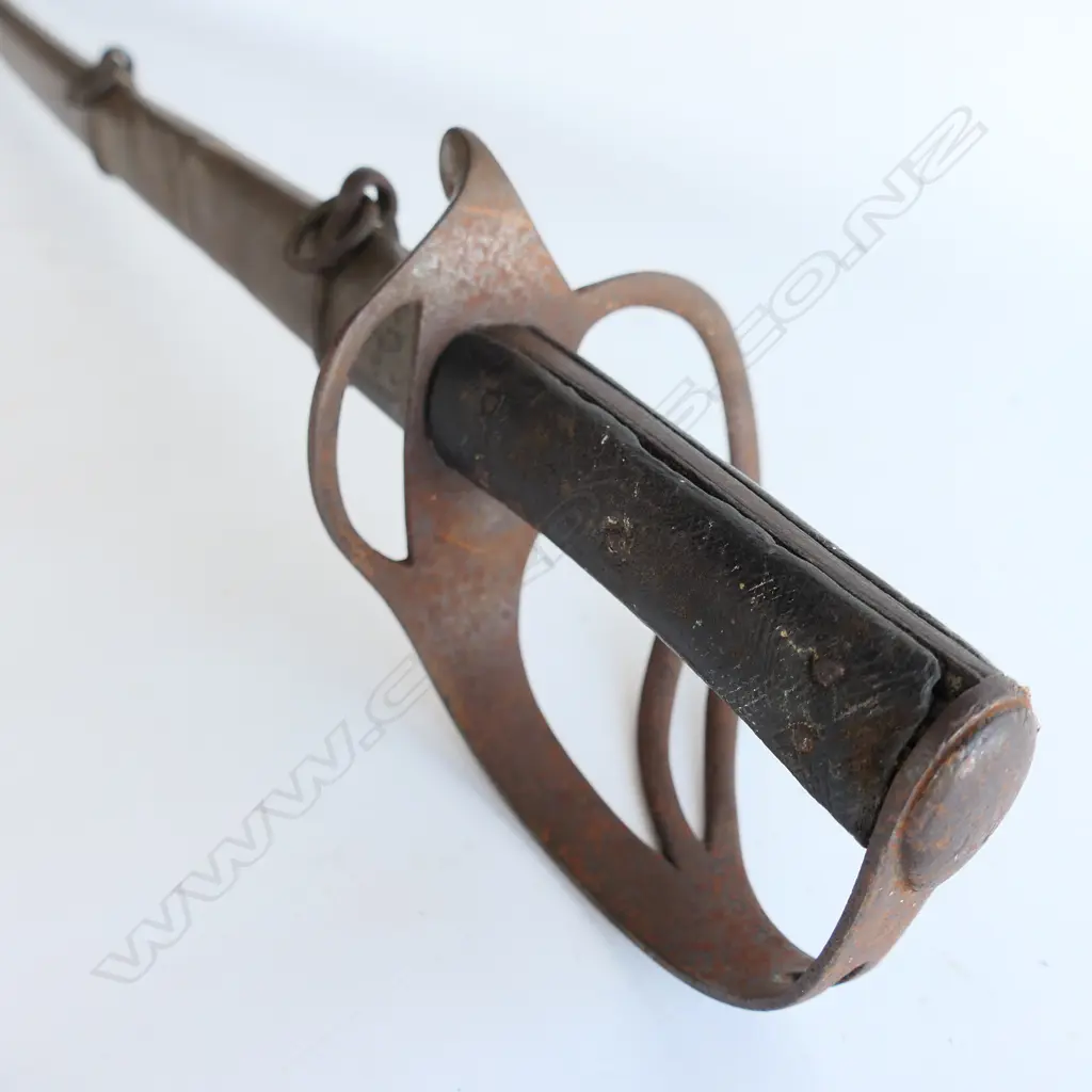 An 1853 Pattern Cavalry Trooper's sword and scabbard, the 895mm single edge fullered steel blade stamped to back edge ‘Mole’ for Robert Mole, Birmingham, Image 1++