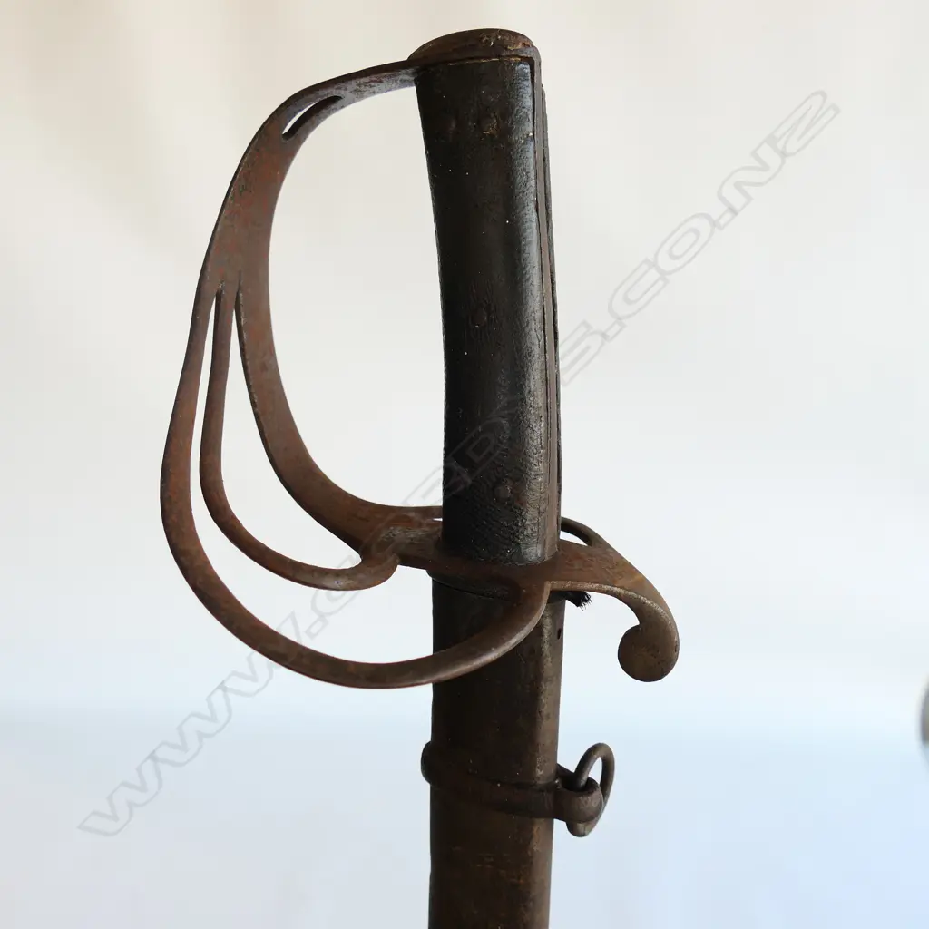 An 1853 Pattern Cavalry Trooper's sword and scabbard, the 895mm single edge fullered steel blade stamped to back edge ‘Mole’ for Robert Mole, Birmingham, Image 1++