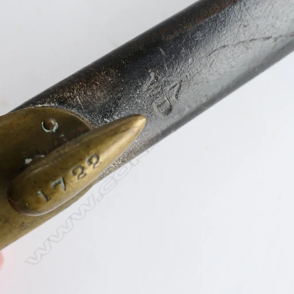 British 1853 Enfield Triangular Socket Bayonet (‘1722’) and matching scabbard (‘WD broad arrow’ and ‘1722’), brass mounted black leather scabbard in good condition. Image 1++