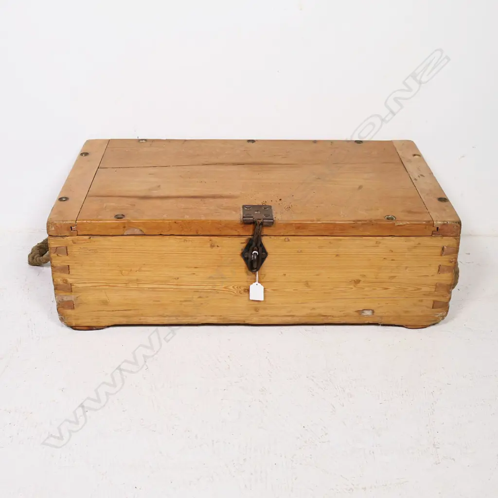 A late 19thC military pine military equipment box, one of the dovetailed corners stamped with serial numbers and other markings, with rope handles to either end, the hinged lid with morticed, clenched ends and provision for screw downs to all edges and additionally a (later) steel clasp lock. 710 x 390 x 230mm. Image 1++