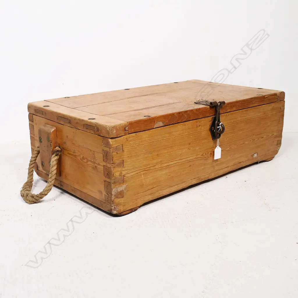 A late 19thC military pine military equipment box, one of the dovetailed corners stamped with serial numbers and other markings, with rope handles to either end, the hinged lid with morticed, clenched ends and provision for screw downs to all edges and additionally a (later) steel clasp lock. 710 x 390 x 230mm. Image 1++