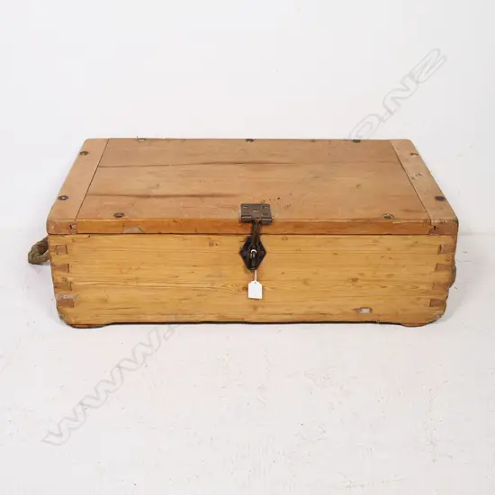 A late 19thC military pine military equipment box, one of the dovetailed corners stamped with serial numbers and other markings, with rope handles to either end, the hinged lid with morticed, clenched ends and provision for screw downs to all edges and additionally a (later) steel clasp lock. 710 x 390 x 230mm.