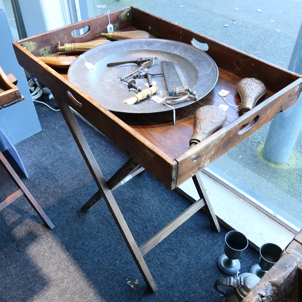 A 19thC teak campaign butler's tray table- the two-handled folding top with brass hinges supported on folding X-framed base. 770 x 510mm Image 1++