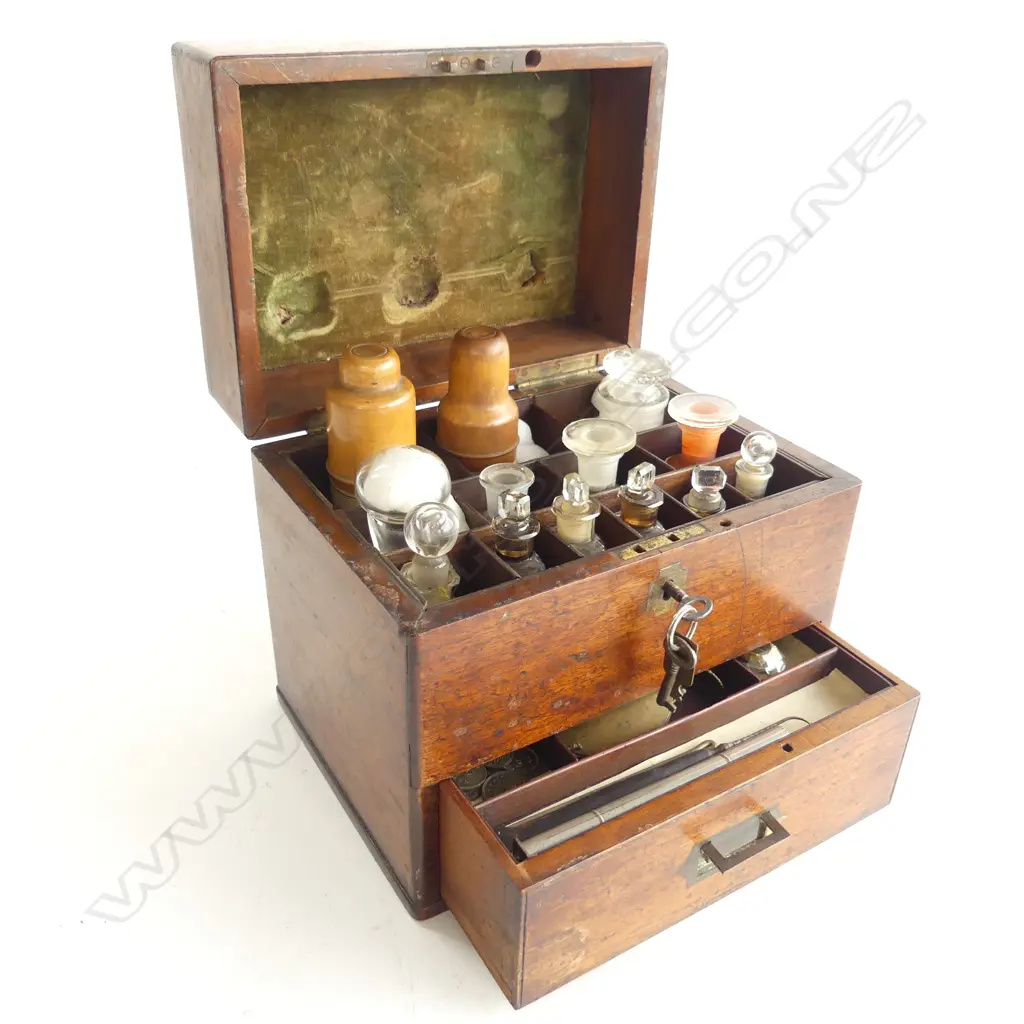 A 19thC apothecary’s mahogany box, with selection of dispensary bottles including two in turned boxwood protective sleeves, marked Allen & Hanburys, London. Image 1++