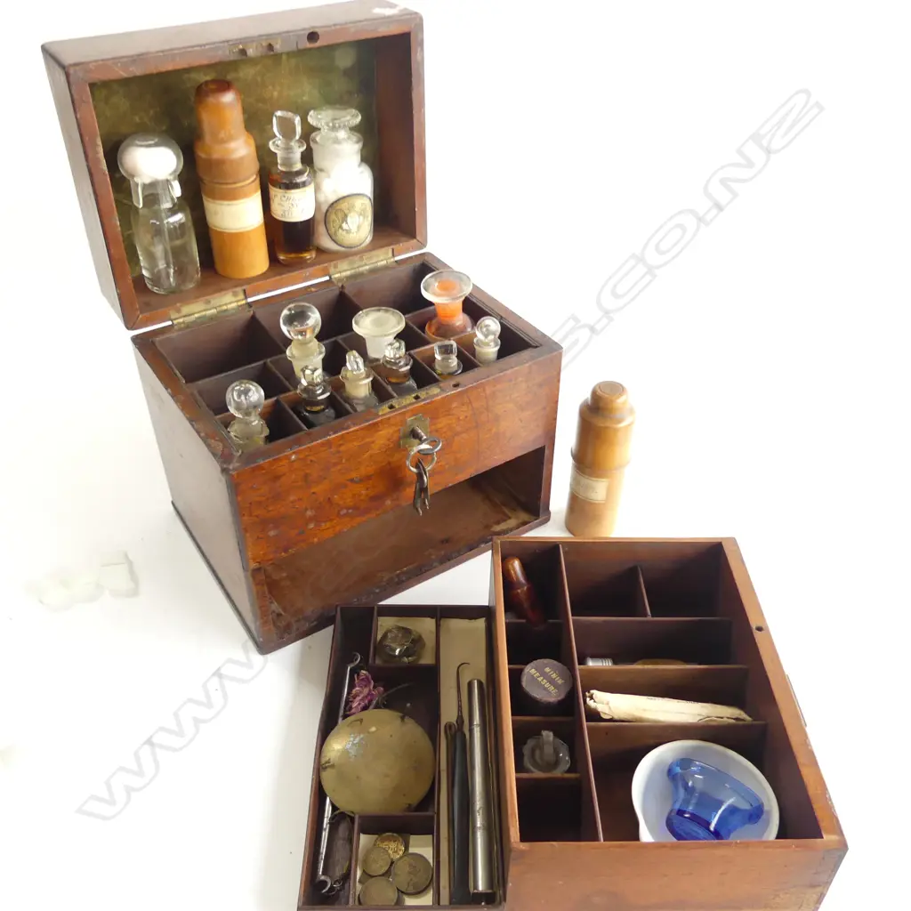 A 19thC apothecary’s mahogany box, with selection of dispensary bottles including two in turned boxwood protective sleeves, marked Allen & Hanburys, London. Image 1++