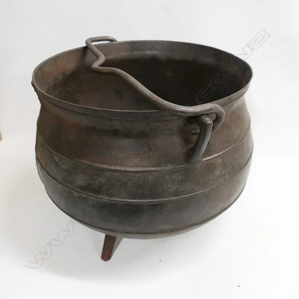 An old cast iron 12 gallon whaling pot made by Falkirk on three splay feet with removable swing handle. Dia.440, H.360mm. Image 1++