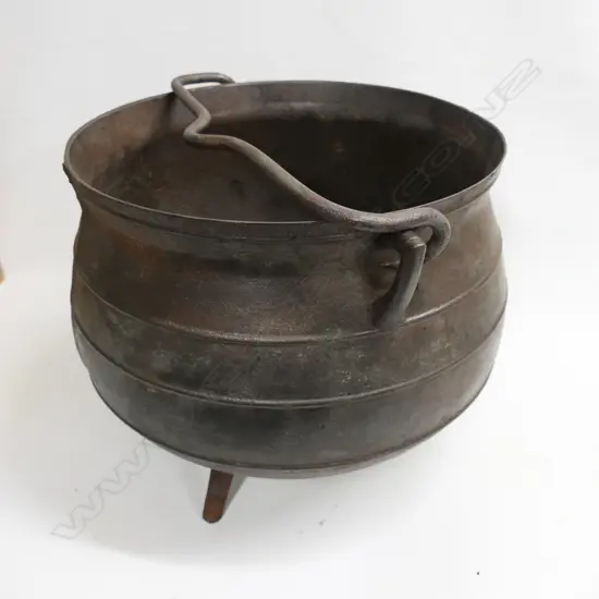 An old cast iron 12 gallon whaling pot made by Falkirk on three splay feet with removable swing handle. Dia.440, H.360mm.