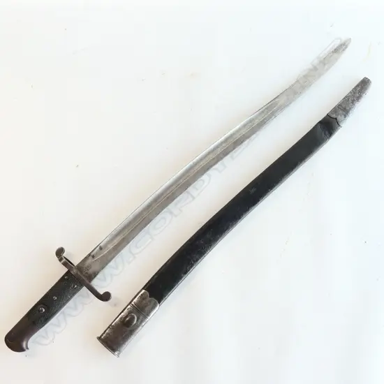 British P.1856/58 Sword Bayonet. Good leather grips. Bar on barrel fitting. Cross guard numbered ‘01258’. Yataghan blade edge with some old file marks and a small amount of old pitting at the tip. Leather scabbard with old dent by chape and chape tip holed