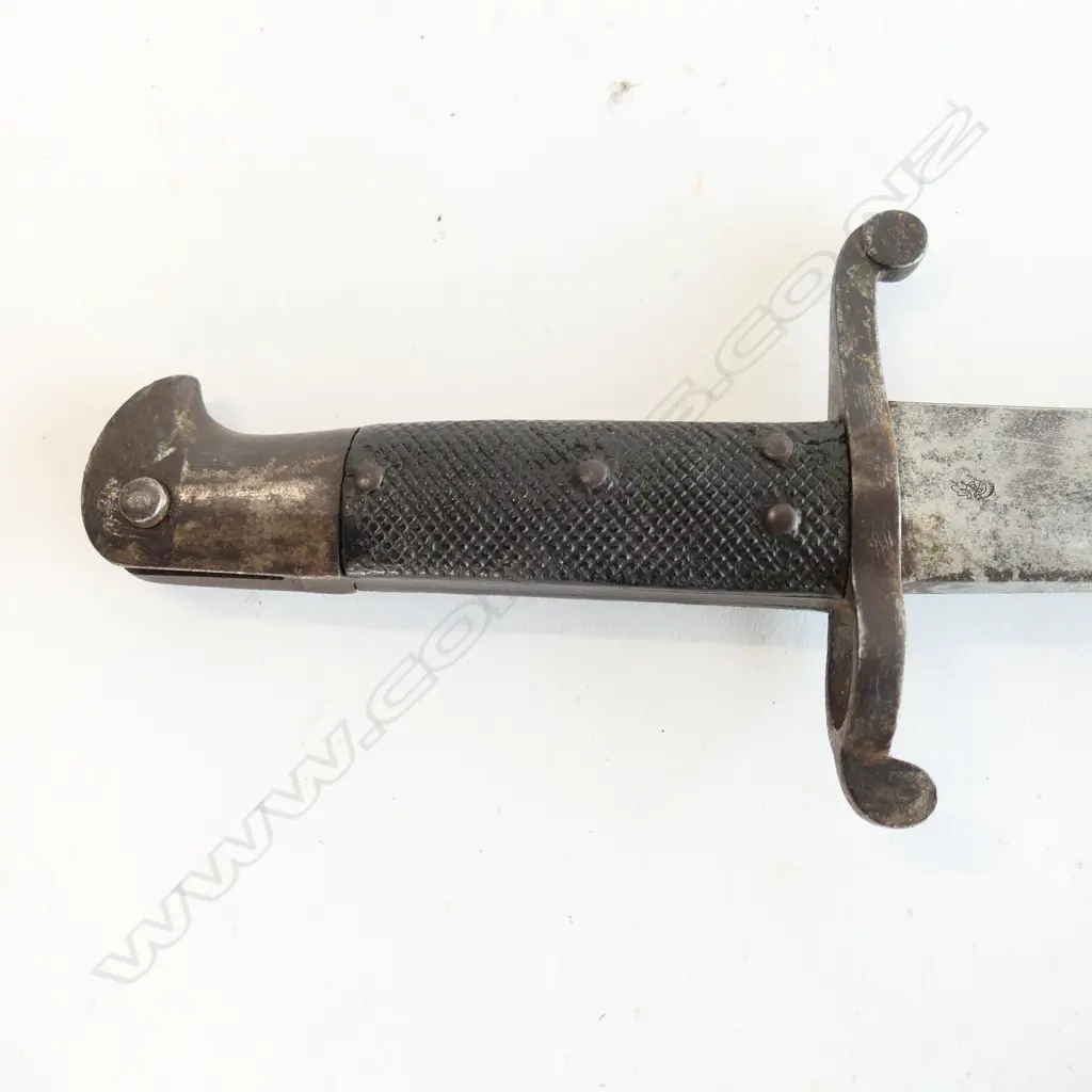 British P.1856/58 Sword Bayonet and Steel Scabbard, Yataghan blade with minor pitting and staining, over-stamped numbers at crossguard, armoury and ‘WD’ markings at ricasso. Good leather grips. The scabbard has overall browning with some pitting. Image 1++