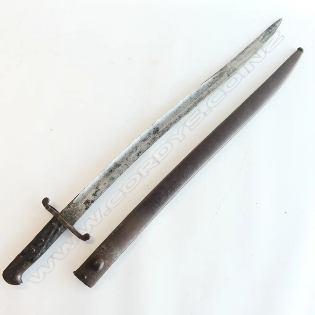 British P.1856/58 Sword Bayonet and Steel Scabbard, Yataghan blade with minor pitting and staining, over-stamped numbers at crossguard, armoury and ‘WD’ markings at ricasso. Good leather grips. The scabbard has overall browning with some pitting. Image 1++