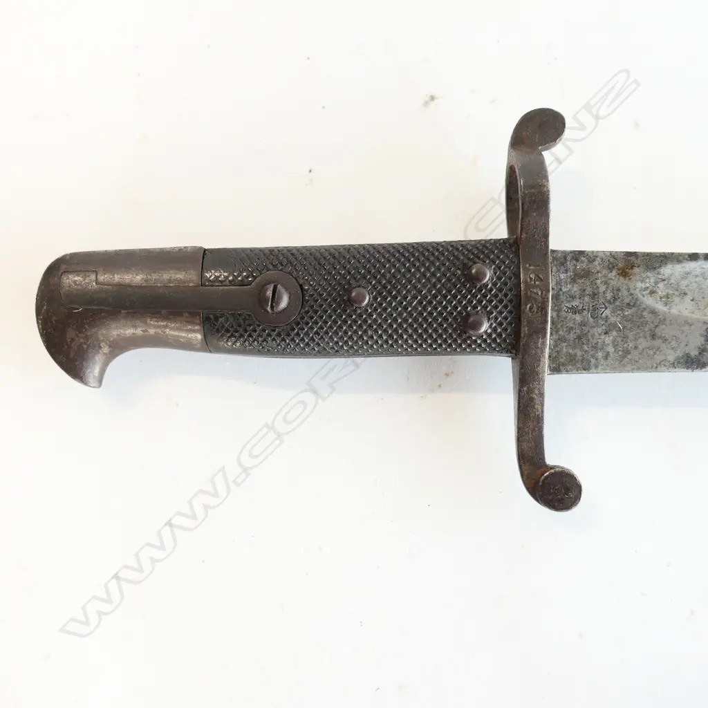 British P.1856/58 Sword Bayonet and Steel Scabbard, Yataghan blade with minor pitting and staining, over-stamped numbers at crossguard, armoury and ‘WD’ markings at ricasso. Good leather grips. The scabbard has overall browning with some pitting. Image 1++