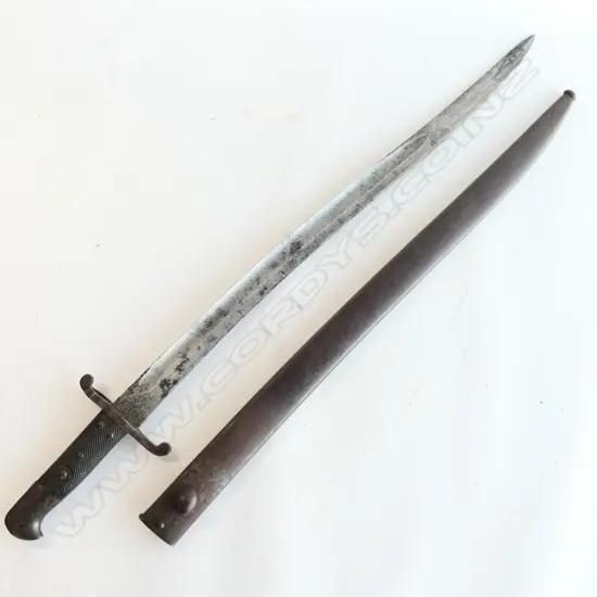 British P.1856/58 Sword Bayonet and Steel Scabbard, Yataghan blade with minor pitting and staining, over-stamped numbers at crossguard, armoury and ‘WD’ markings at ricasso. Good leather grips. The scabbard has overall browning with some pitting.