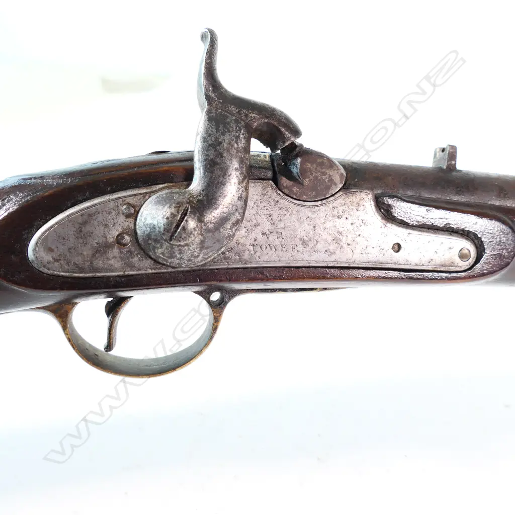 Enfield pattern 1839 percussion musket. .75 caliber, converted from Brown Bess. Brass butt plate marked broad arrow 2/65 NZ. Lock plate marked 'Crown VR Tower'. Image 1++