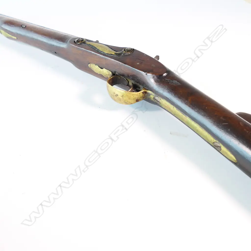 Enfield pattern 1839 percussion musket. .75 caliber, converted from Brown Bess. Brass butt plate marked broad arrow 2/65 NZ. Lock plate marked 'Crown VR Tower'. Image 1++