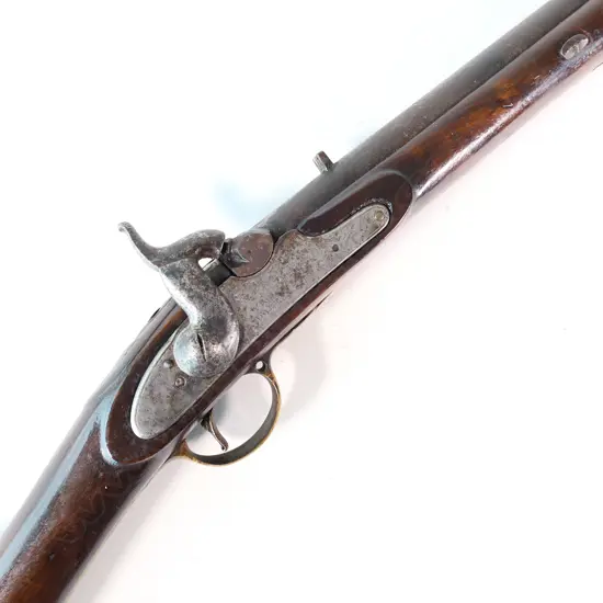 Enfield pattern 1839 percussion musket. .75 caliber, converted from Brown Bess. Brass butt plate marked broad arrow 2/65 NZ. Lock plate marked 'Crown VR Tower'.