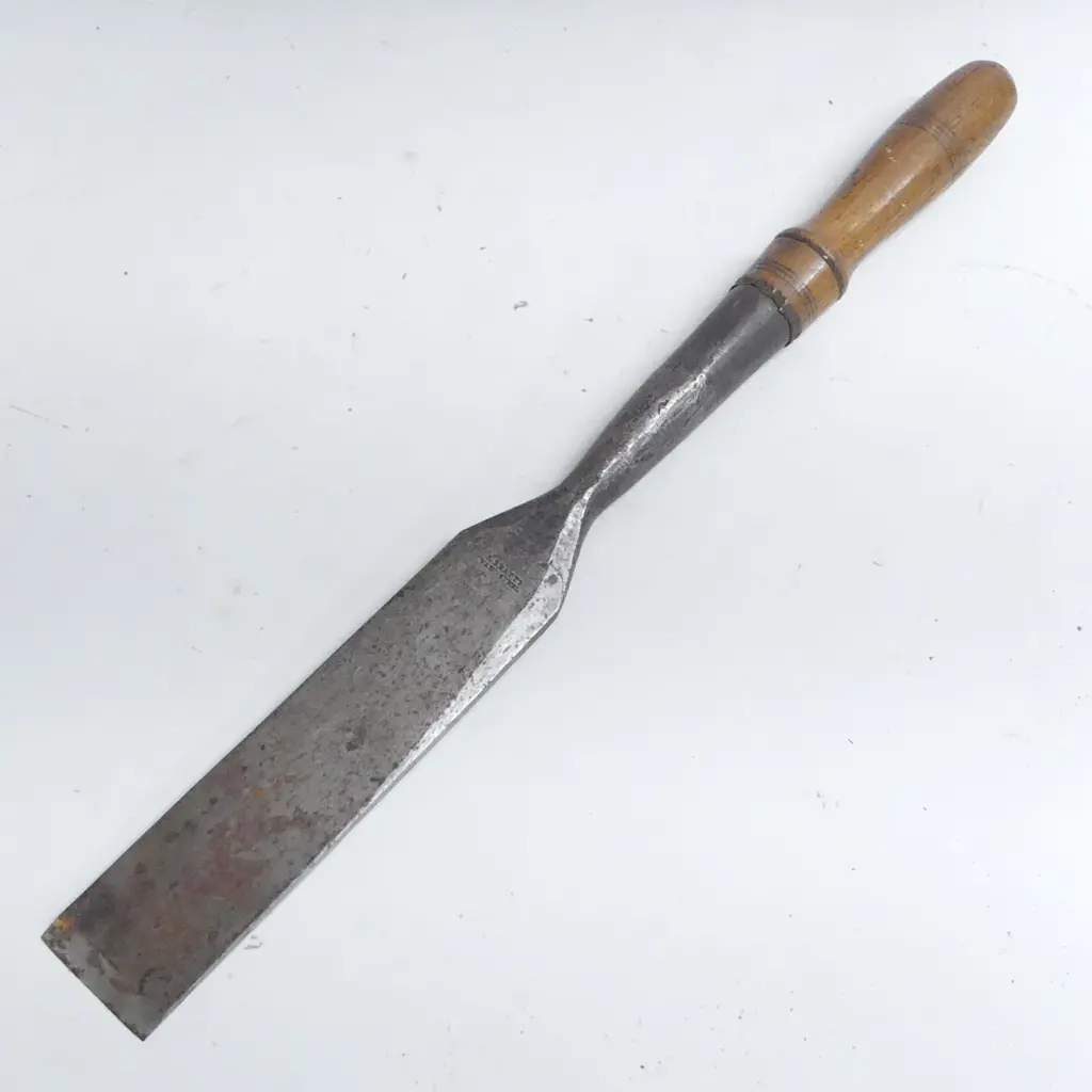 A 19thC J.Beaty 2½" hand forged large mortise chisel, makers name to blade. Turned oak handle to the socket fitting. L.640mm Image 1++