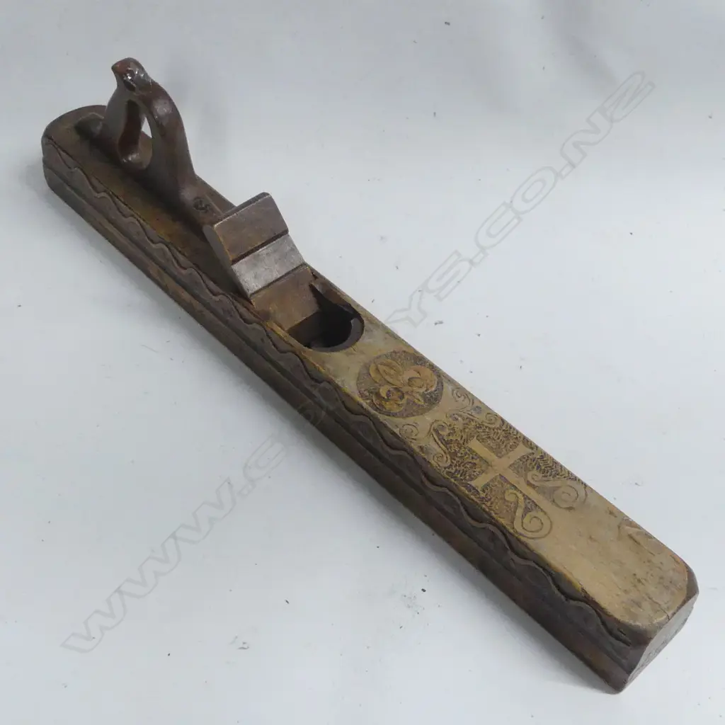 An early wooden fore or jack plane, deeply carved showing crucifix on top and wavy line on sides. Image 1++