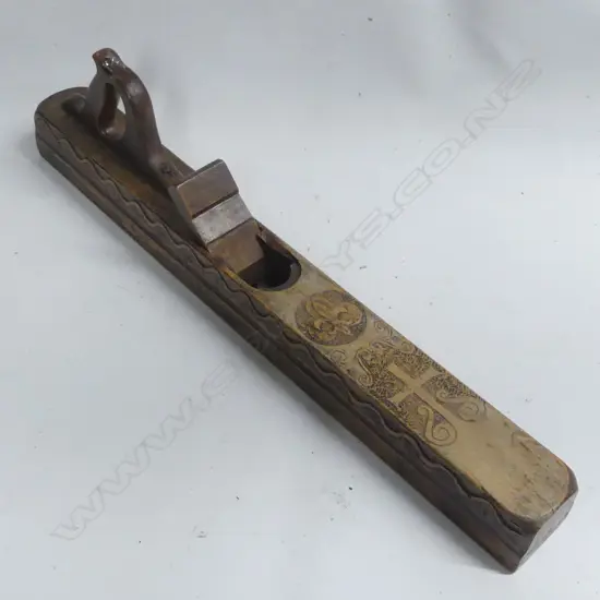 An early wooden fore or jack plane, deeply carved showing crucifix on top and wavy line on sides.