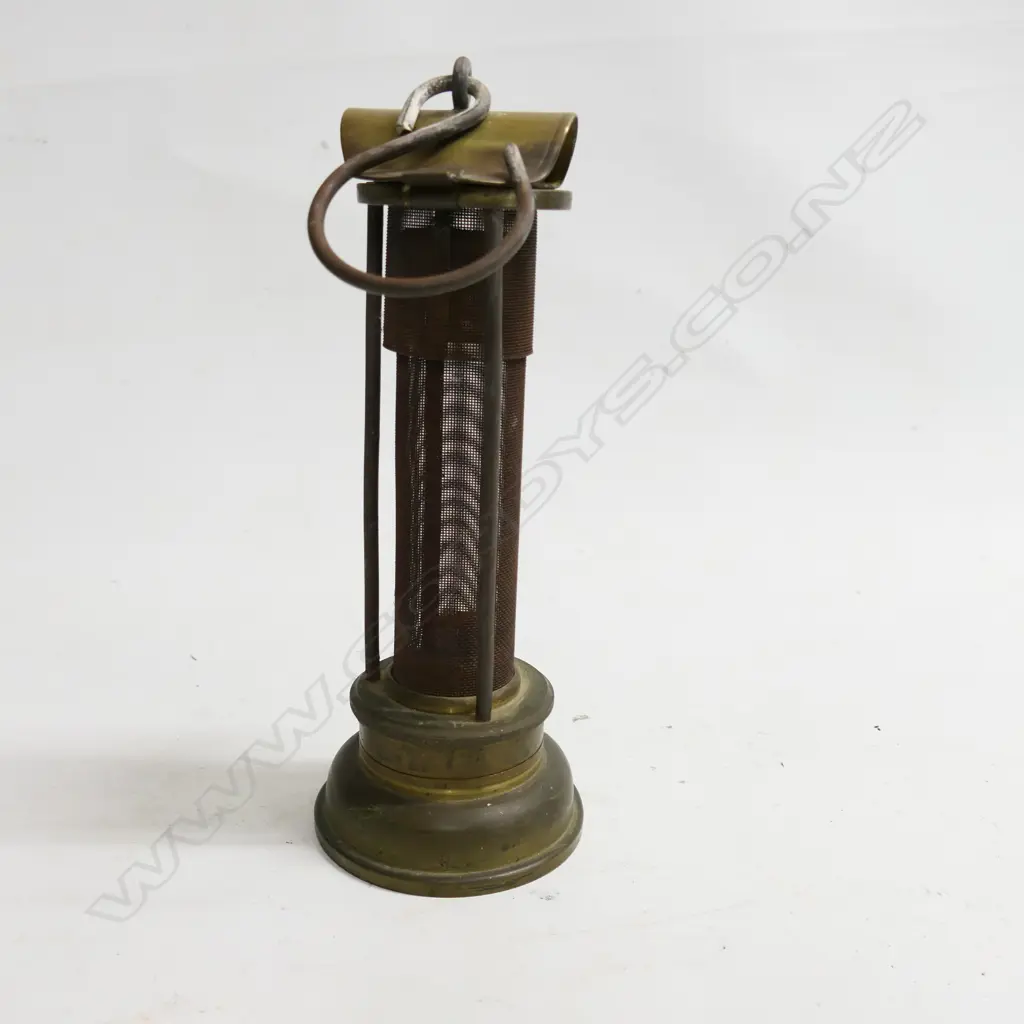 A Thomas & Williams brass miner's brass Safety Lamp c. 1900. The body being a long gauze section protected by three bars. H.235mm. Image 1++