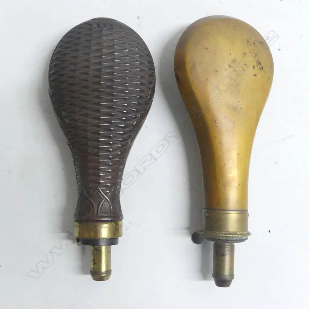 Two Victorian copper and brass powder flasks with graduated dispenser nozzles one of plain bag shape with nozzle to dispense 2 to 2¾ drams, the other decorated with basket weave, the nozzle marked Dixon & Sons, Made in England. Image 1++
