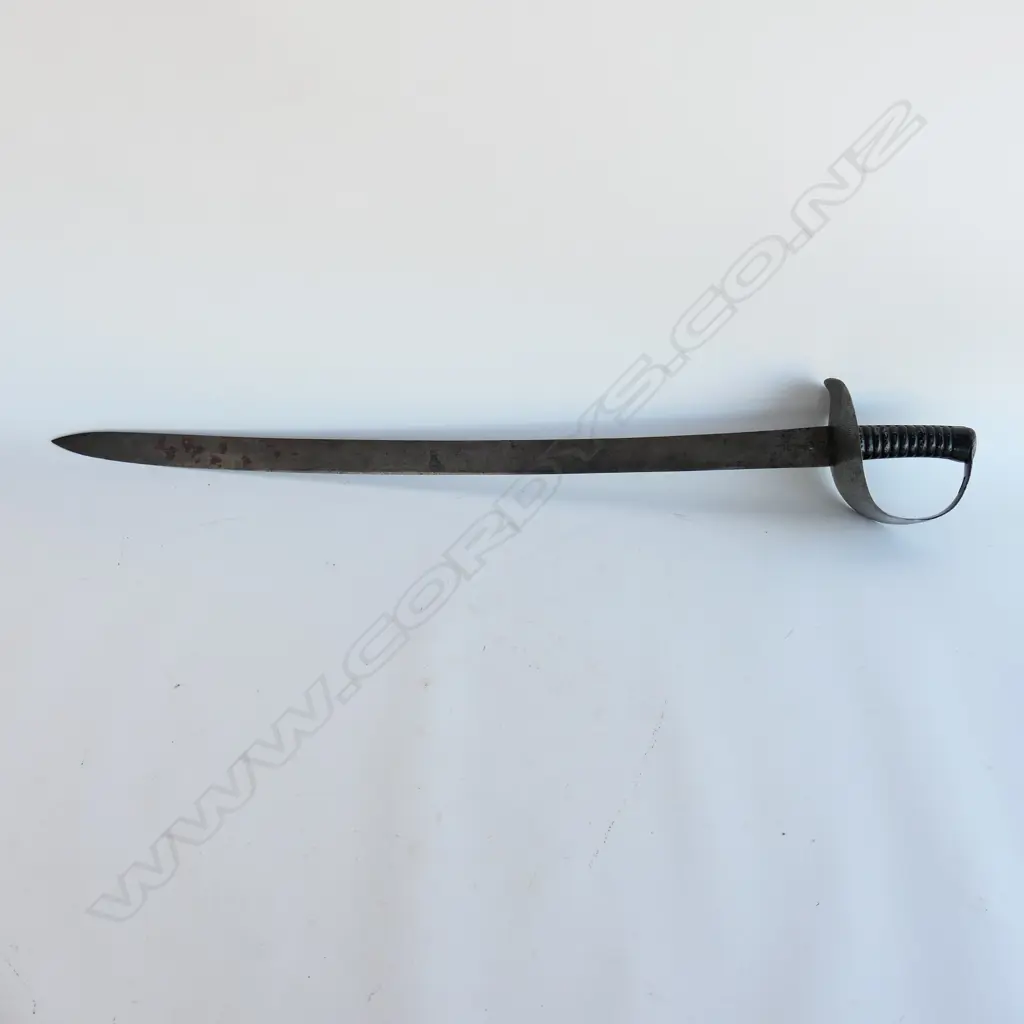An 1845 Pattern Navy Cutlass. 740mm long, single edged blade with spear point. Makers logo inside shield ‘Wilkinson, Pall Mall, London’. Image 1++