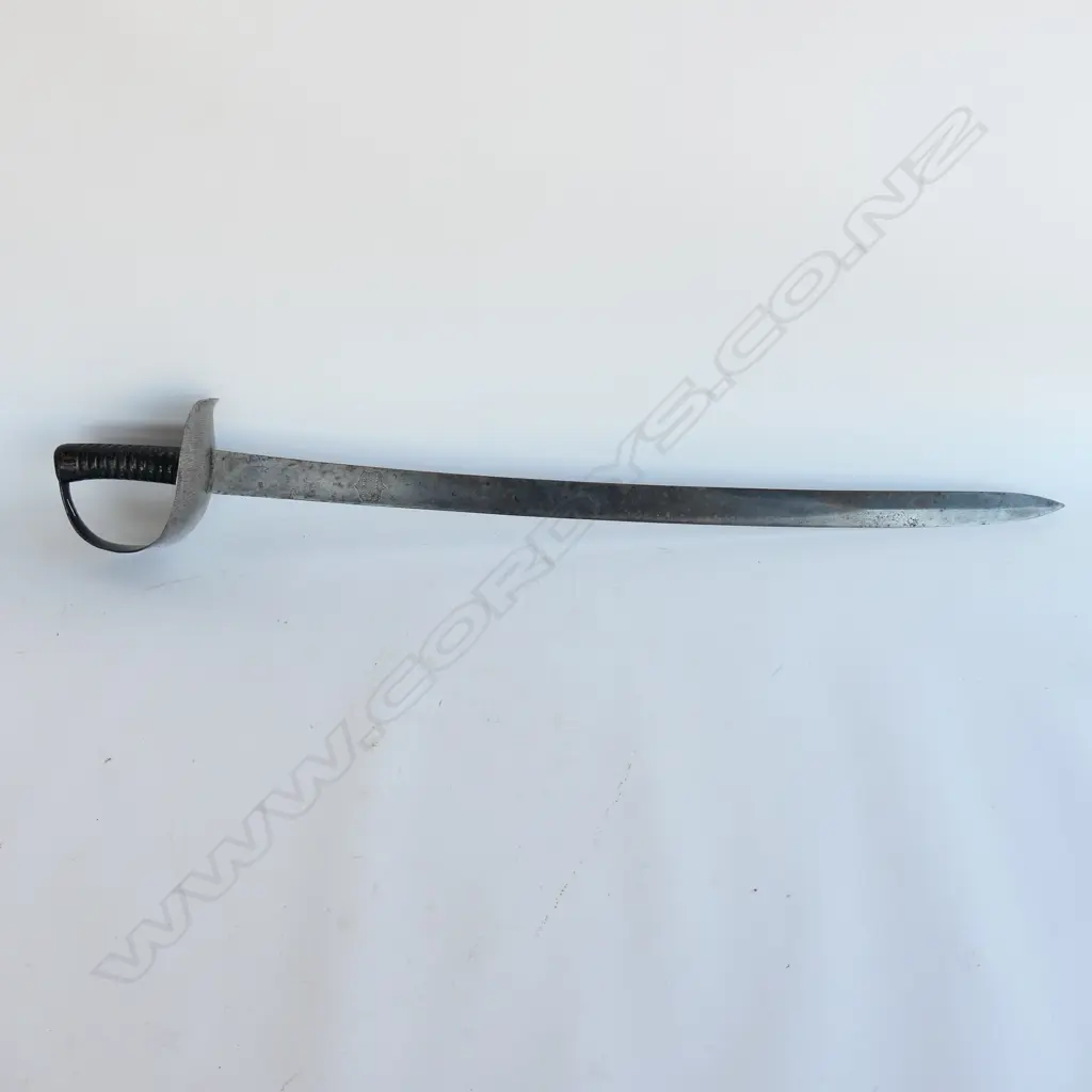 An 1845 Pattern Navy Cutlass. 740mm long, single edged blade with spear point. Makers logo inside shield ‘Wilkinson, Pall Mall, London’. Image 1++