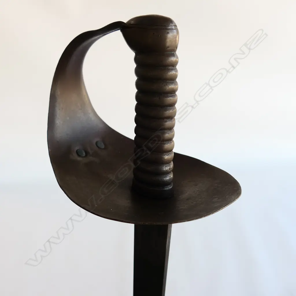 An 1845 Pattern Navy Cutlass. 685mm long, single edged blade with spear point, cleaned, shortened, WD marks and "C/88" Image 1++