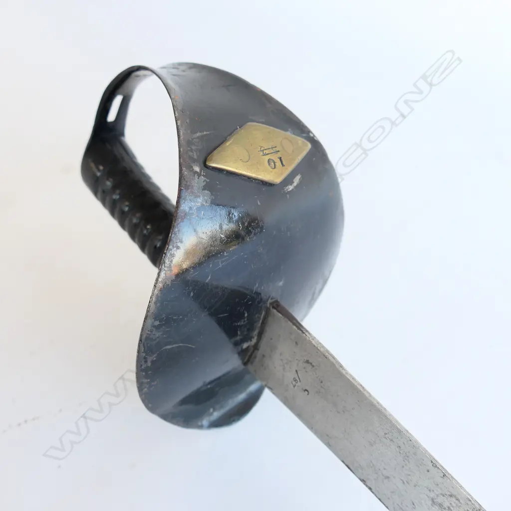 An 1845 Pattern Navy Cutlass. 635mm long, single edged blade with spear point by Robert Mole. Black painted steel bowl with diamond shaped plaque affixed marked '10' and with '53' erased, grooved cast iron grips. Mole marked to blade back, WD marks, armoury marks and C/87 at ricasso, Image 1++