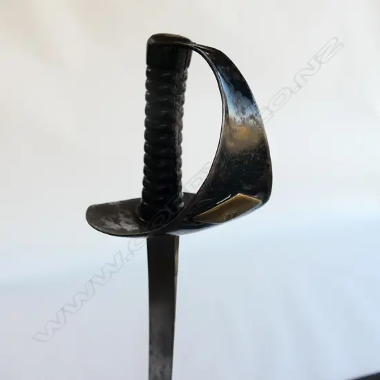 An 1845 Pattern Navy Cutlass. 635mm long, single edged blade with spear point by Robert Mole. Black painted steel bowl with diamond shaped plaque affixed marked '10' and with '53' erased, grooved cast iron grips. Mole marked to blade back, WD marks, armoury marks and C/87 at ricasso,