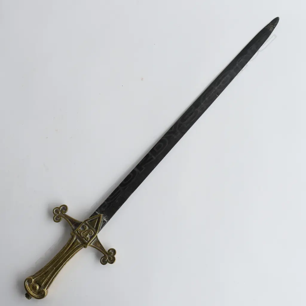 British Drummers’ Pattern 1856 Sword. 495mm slender double-edged spear point blade, brass cruciform hilt with Victorian cypher. Blade a brown patina with some pitting mainly on the point. Image 1++