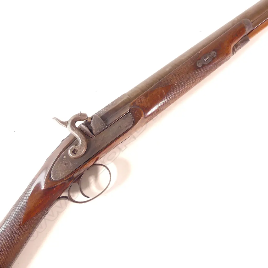 Hollis and Sheath single barrel fowling shotgun.12 gauge percussion. Attractive damascus twist pattern barrel. Wooden ramrod. Nice walnut stock with checquering to wrist and fore end. Barrel with London address line. Image 1++