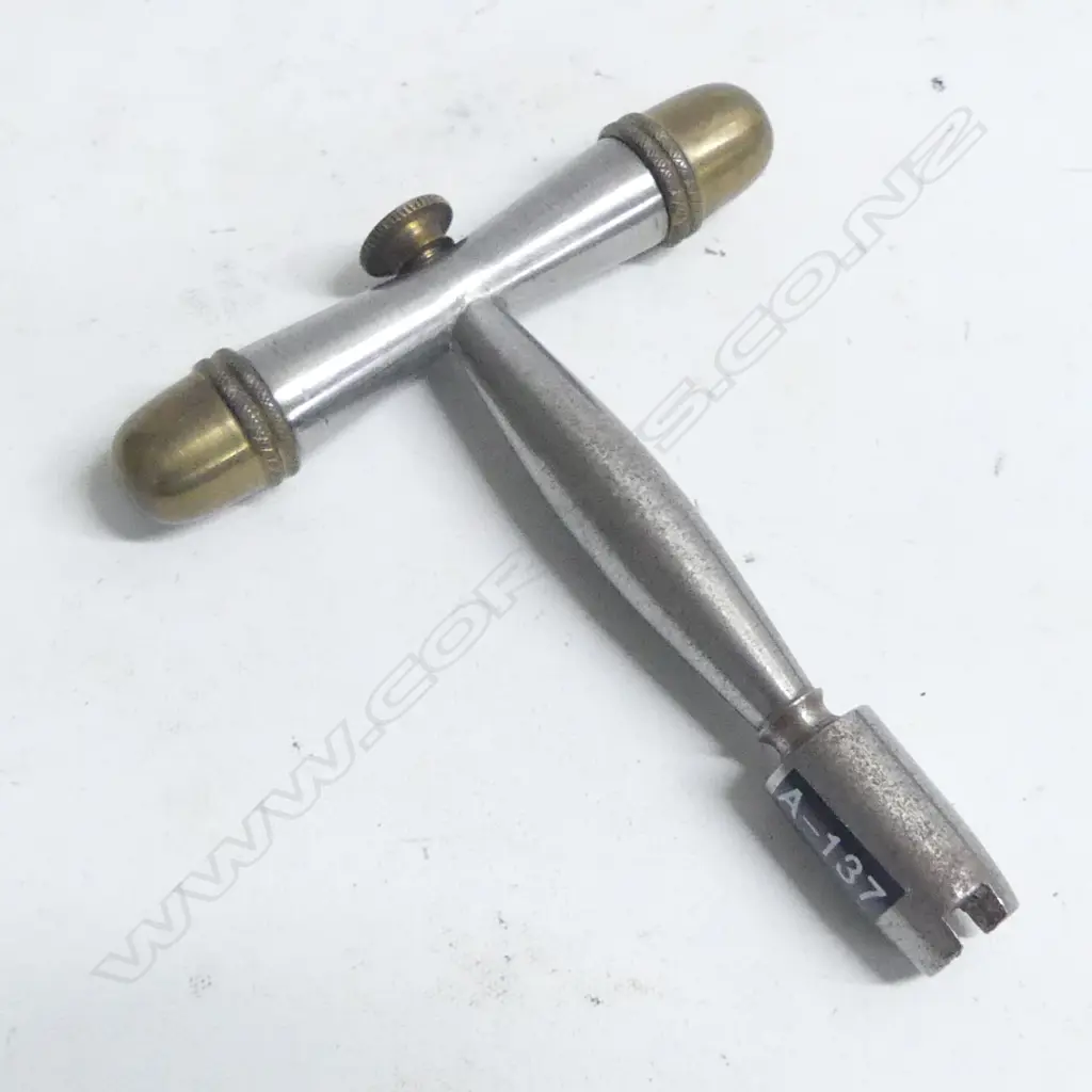 A nipple key by Peter Dyson, Yorkshire, England, steel with brass end caps. Image 1++