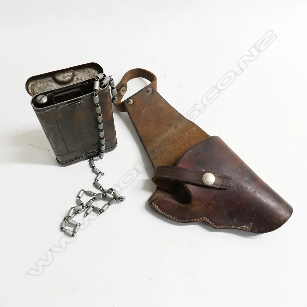 A vintage stitched leather pistol holster and a travelling gun cleaning kit Image 1++